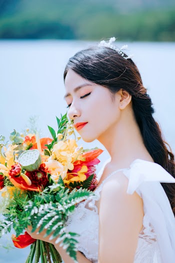 Close-Up Photo of Woman Holding Bouquet