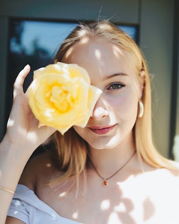 Close-Up Photo of Woman Holding Flower