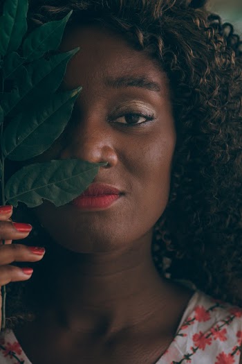 Close-up Photo of Woman Holding Green Leaf Over Her Eye