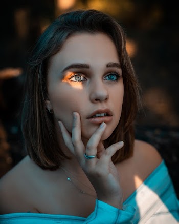 Close-Up Photo of Woman Holding Her Chin