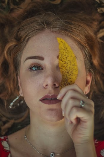 Close-Up Photo of Woman Holding Leaf