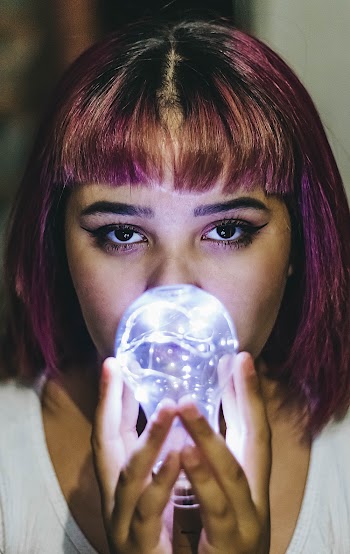 Close-Up Photo of Woman Holding Light Bulb