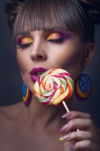 Close-UP Photo of Woman Holding Lollipop