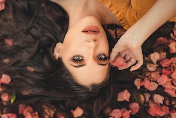 Close-Up Photo Of Woman Holding Petal