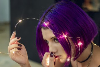 Close-Up Photo of Woman Holding String Lights
