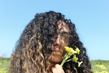 Close-Up Photo of Woman Holding Yellow Flower