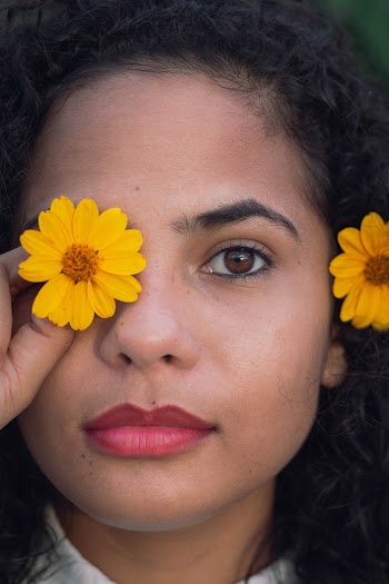 Close-Up Photo of Woman Holding Yellow Flower