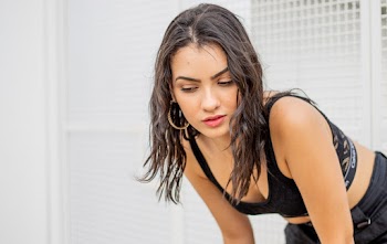 Close-up Photo of Woman In Black Sports Bra Bending Over