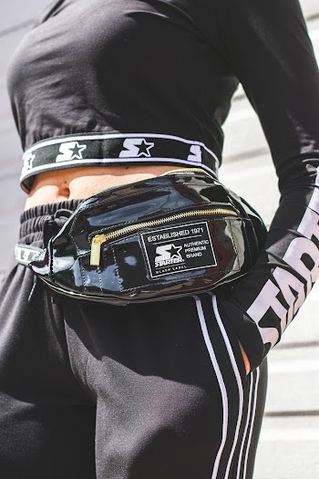 Close-up Photo of Woman in Black Starter Crop Top, Sweatpants and Fanny Pack