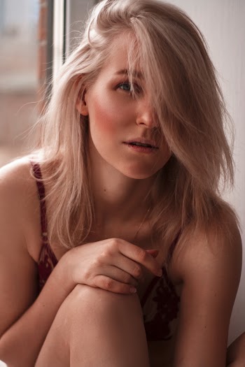 Close-up Photo of Woman in Red Floral Brassiere Posing