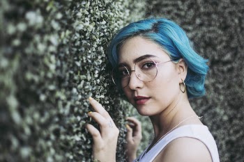 Close-Up Photo of Woman Leaning On Bush