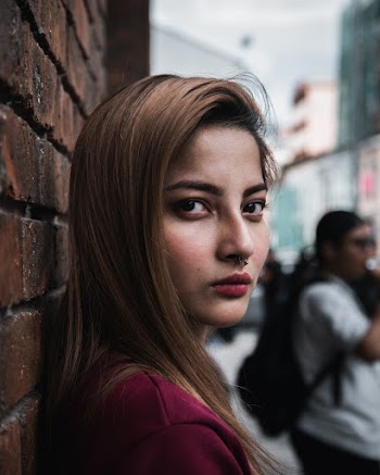 Close-Up Photo Of Woman Leaning On The Wall