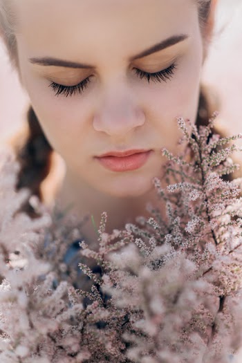 Close-Up Photo of Woman Near Flower