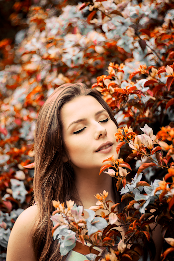 Close-Up Photo of Woman Near Flowers