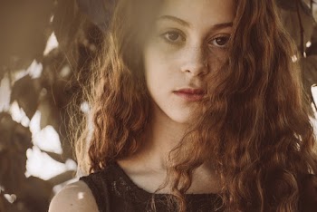 Close-Up Photo of Woman Near Leaves