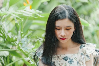 Close-Up Photo of Woman Near Leaves