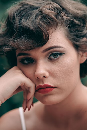 Close-up Photo of Woman Resting Hand on Her Chin