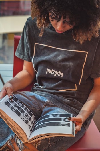 Close-up Photo of Woman Sitting While Reading Book