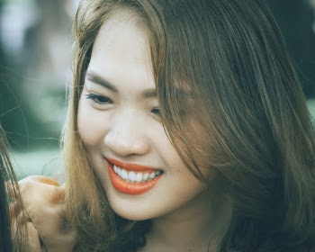 Close-up Photo of Woman Smiling