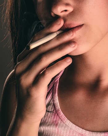 Close-Up Photo Of Woman Smoking Cigarette