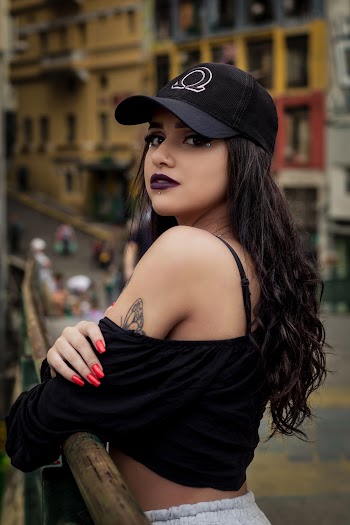 Close-Up Photo of Woman Wearing Black Cap