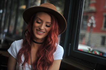 Close-Up Photo Of Woman Wearing Brown Fedora