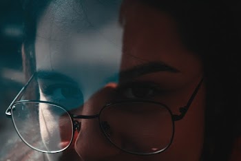 Close-Up Photo of Woman Wearing Eyeglasses