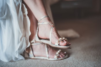 Close-Up Photo of Woman Wearing Flat Sandals