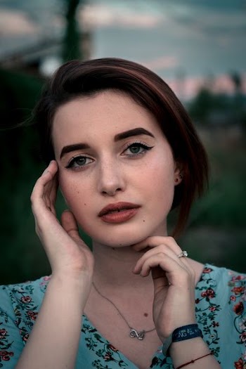 close up photo of woman wearing white and red floral shirt