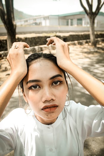 Close-Up Photo of Woman Wearing White Top