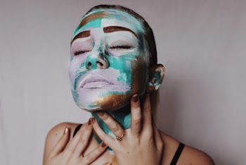 Close-up Photo of Woman With Her Eyes Closed Covered in Face Paint