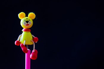 Close-up Photo of Yellow and Red Mouse Character Toy