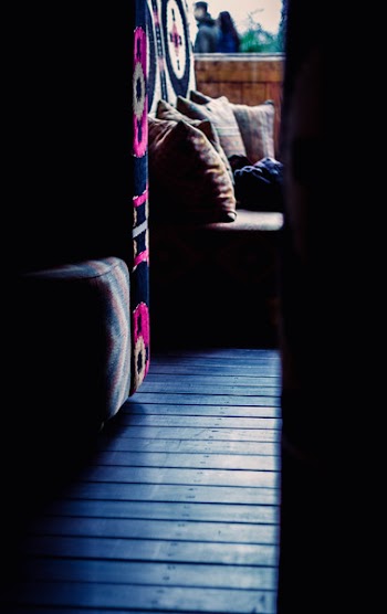 Close Up Photograph of Sofa Chair Near Round Ottoman