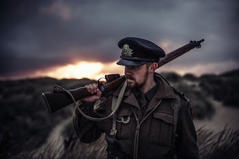 Close-Up Photography of a Man Holding Rifle