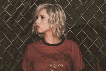 Close-Up Photography of a Woman Leaning On Chain Link Fence