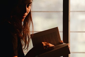 Close-Up Photography of a Woman Reading