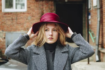 Close-Up Photography of a Woman Wearing Purple Hat