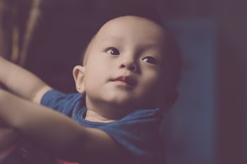 Close-Up Photography of Baby Looking Up