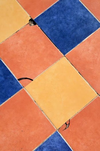 close-up photography of blue, orange, and yellow tile surface