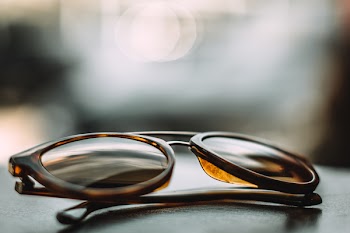 Close-up Photography of Brown Framed Sunglasses on Gray Surface