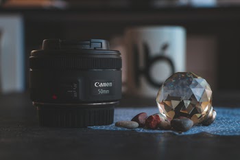 Close-Up Photography of Camera Lens Near Gem