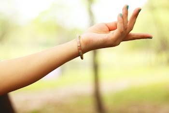 Close-Up Photography of Girl's Left Hand Wearing Bracelet