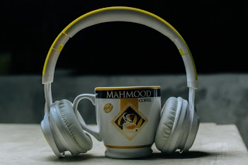 Close-Up Photography of Headset Near Cup