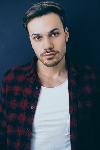 Close-up Photography of Man in White Top Wearing Red and Black Jacket