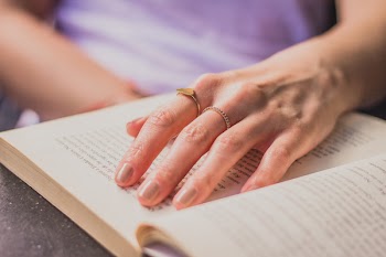Close-up Photography Of Person Holding Opened Book