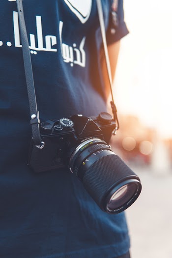 Close-up Photography of Person Wearing Black Point-and-shoot Camera