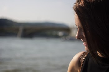 Close Up Photography of Side View Angle of a Woman Smiling Near Seawater during Daytime