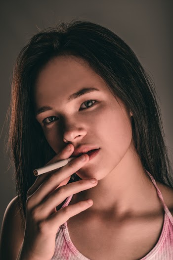 Close-up Photography Of Woman Holding White Cigarette Stick