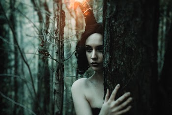 Close-up Photography of Woman Standing Beside Tree