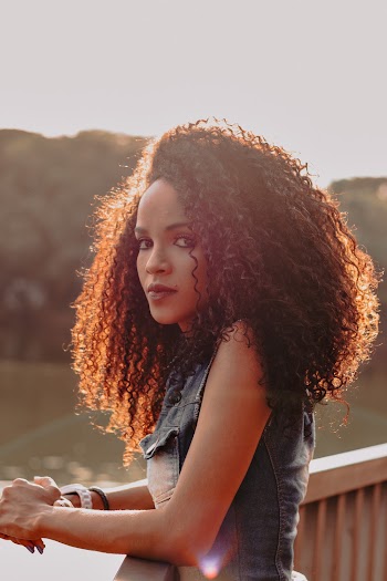 Close-up Photography of Woman Standing on Wooden Porch